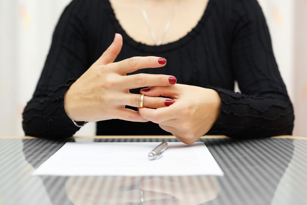 Woman taking off ring